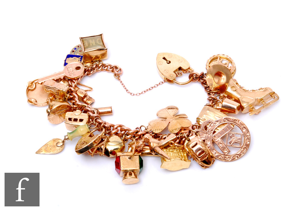 A 9ct rose gold curb link bracelet terminating in padlock fastener with various charms attached to