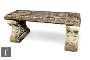 A reconstituted stone garden bench, raised in two scalloped pedestal plinth, with flat top, height
