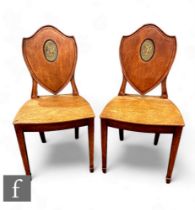 A pair of late 19th Century mahogany hall chairs, plank seats below shaped backs inset with green