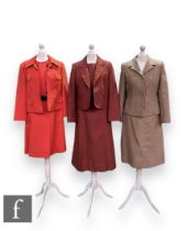 Three 1960s vintage two piece suits, comprising Hucke Model dress and jacket in red with black