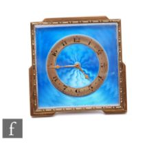 An Edwardian bedside brass easel clock, radiating blue enamelled dial, width 7cm.