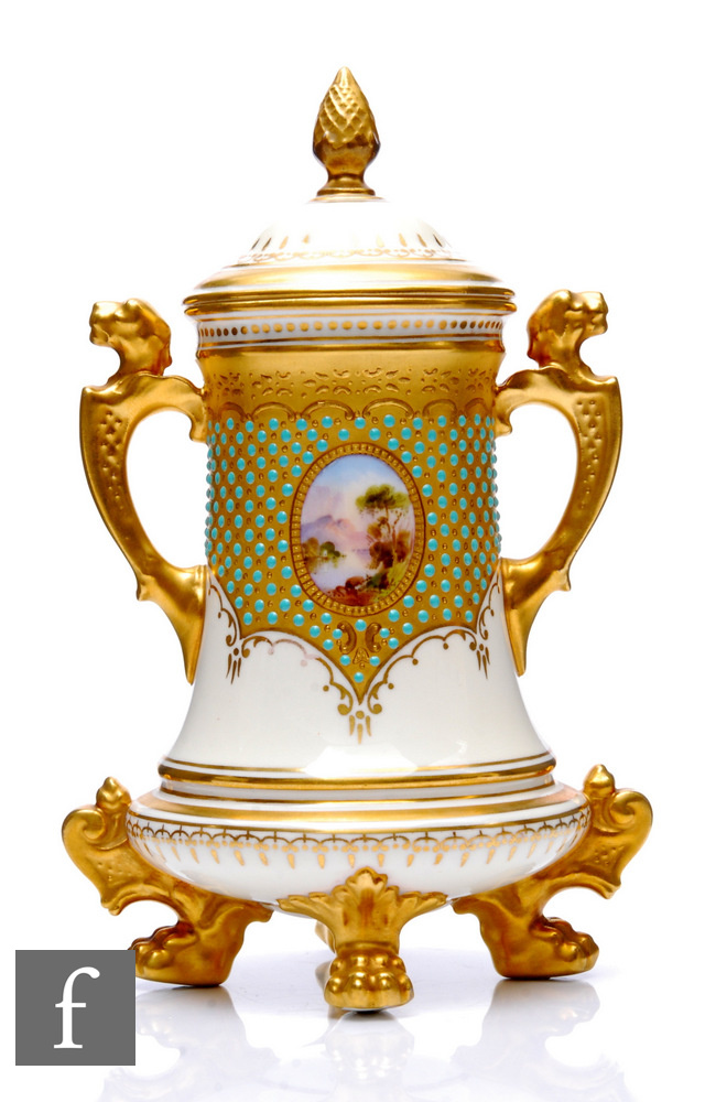 A Coalport porcelain 'Jewelled' vase and cover, circa 1900, raised on gilt paw feet surmounted