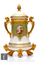 A Coalport porcelain 'Jewelled' vase and cover, circa 1900, raised on gilt paw feet surmounted