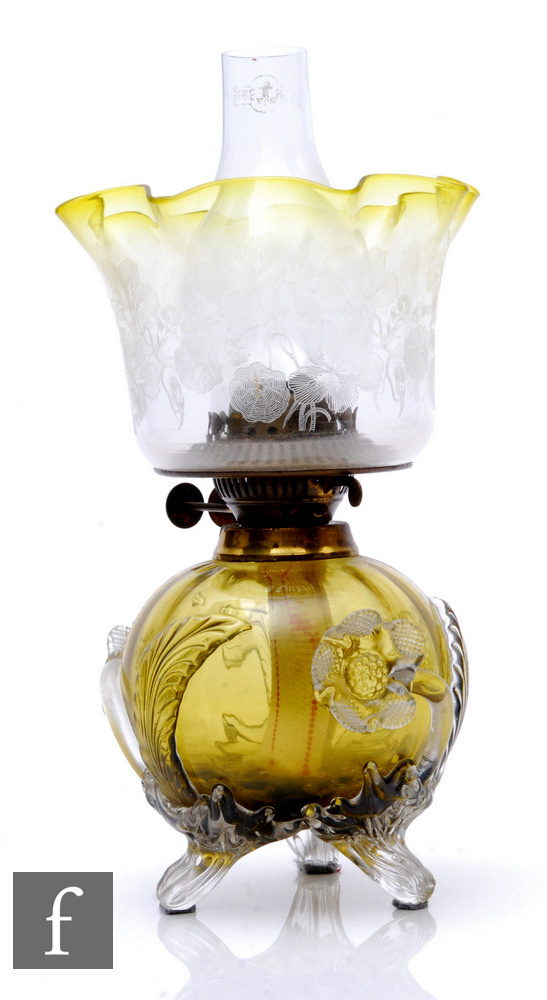 A late 19th Stourbridge glass oil lamp, the citron compressed ovoid and fluted body decorated with