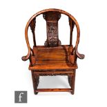A Chinese officials chair, the tubular frame with plank seat and sweeping arms, carved to the back