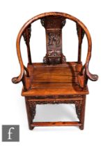 A Chinese officials chair, the tubular frame with plank seat and sweeping arms, carved to the back