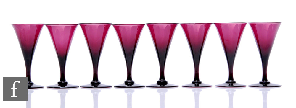 A set of eight 19th Century amethyst wine glasses with a drawn trumpet above a slender plain stem