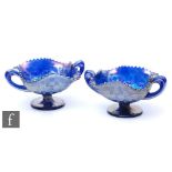 A pair of early 20th Century Carnival glass bon bon dishes with twin handles and wave edged rims, by