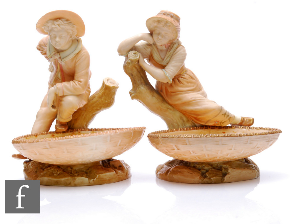 A pair of late 19th century Royal Worcester Hadley blush ivory porcelain figural comports, models