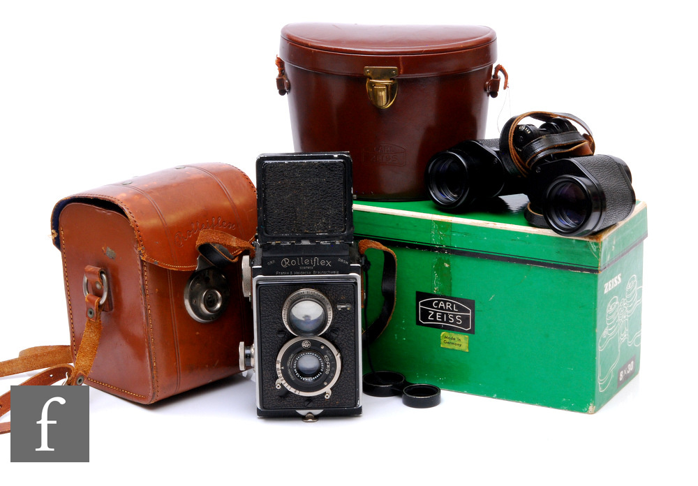 A Rolleiflex camera No 97979, compur shutter and Zeiss Jena lens in leather case and a pair of Zeiss