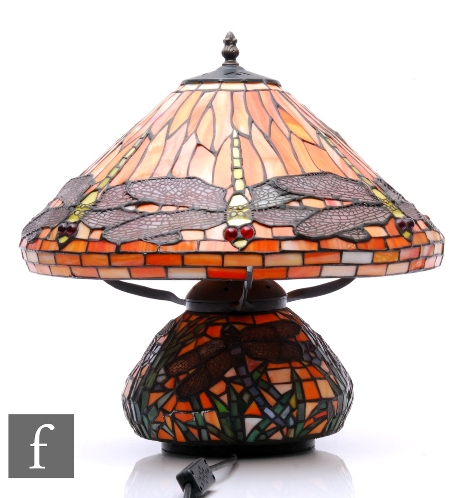 A 20th Century reproduction table lamp in the manner of Tiffany, the compressed ovoid base decorated