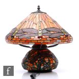 A 20th Century reproduction table lamp in the manner of Tiffany, the compressed ovoid base decorated