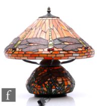 A 20th Century reproduction table lamp in the manner of Tiffany, the compressed ovoid base decorated