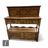 A late 1920s light oak two tier buffet in the 17th Century style, fitted with two geometric