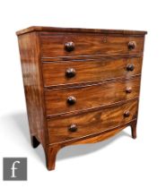 A George III crossbanded mahogany bow front chest of four long graduated drawers, turned wood
