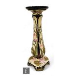 An early 20th Century English tubeline decorated jardiniere stand of swept form rising to a pedestal