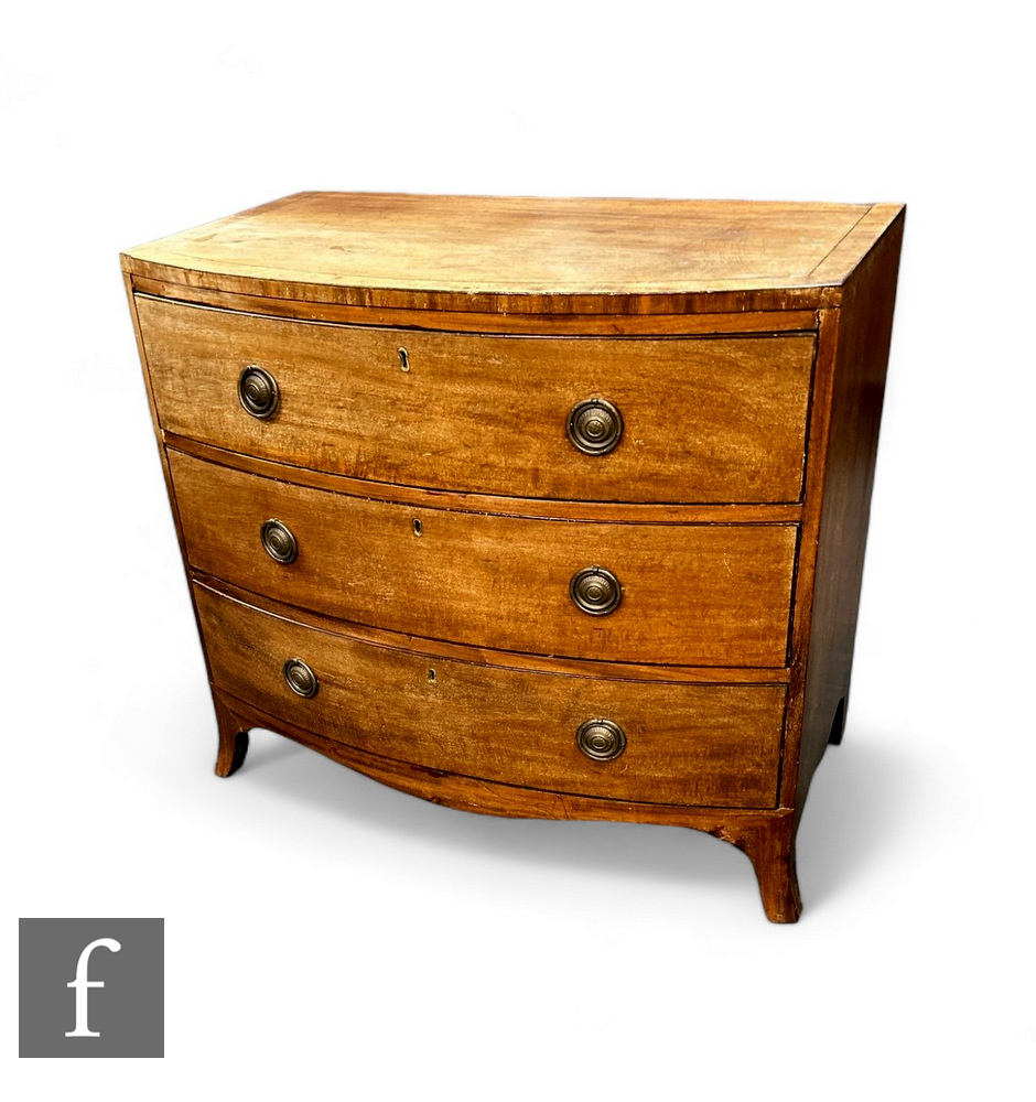 A mahogany George III bow front chest of drawers, the plank top over three long drawers, with