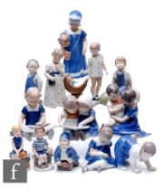 A collection of Royal Copenhagen figures, each modelled as a child engaged in various pastimes and