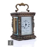 A Chas. Frodsham miniature carriage clock, the silvered four glass and cast case adorned with