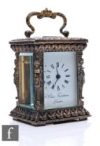 A Chas. Frodsham miniature carriage clock, the silvered four glass and cast case adorned with