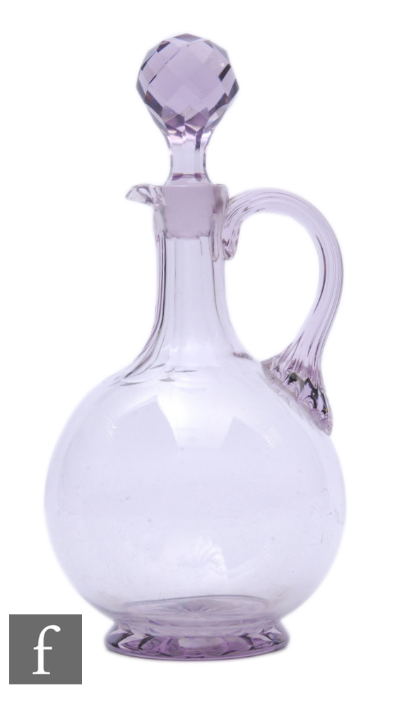 A late Victorian glass decanter of footed globular form with tall collar facet cut neck, with