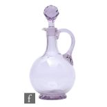 A late Victorian glass decanter of footed globular form with tall collar facet cut neck, with