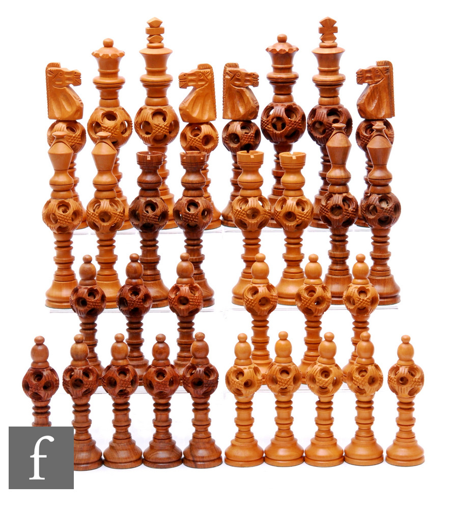 A 1970s Jordanian carved hardwood chess set of turned and concentric centre ball design, height