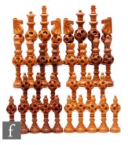 A 1970s Jordanian carved hardwood chess set of turned and concentric centre ball design, height