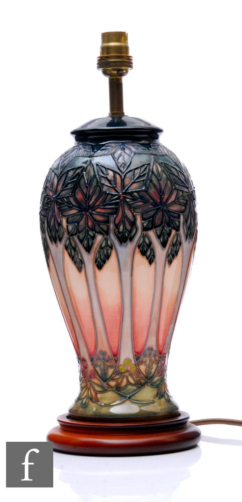 A Moorcroft pottery Cluny pattern table lamp, raised on a wooden base, height 30cm.