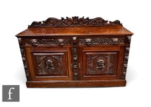 A Victorian carved oak sideboard fitted with two drawers over a panelled cupboard plinth base,