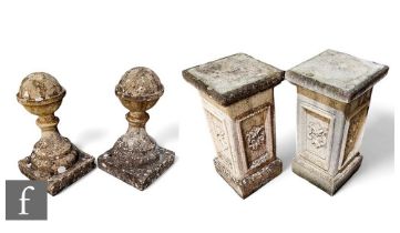 A pair of composite stone ball finials on pedestal square bases, height 117cm. (2)