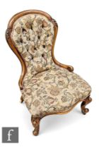 A Victorian nursing chair, the mahogany spoon back frame raised on scrolling supports, with floral