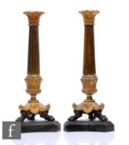 A pair of late 19th Century Louis XVI style gilt metal candle sticks, reeded tapering columns