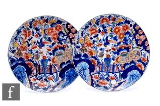 A pair of 19th Century French faience plates, each of circular form decorated in the Chinese taste