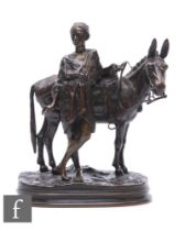 A bronze sculpture by Alfred Dubucand (1828-1894), depicting an Egyptian standing with a mule, on