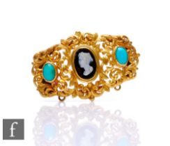 A late 19th to early 20th Century pinchbeck brooch inset with central cameo and two turquoise