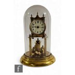 An Edwardian 365 day brass pillar mantle clock, Arabic dial, on circular stepped base, height 30cm.