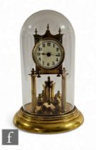 An Edwardian 365 day brass pillar mantle clock, Arabic dial, on circular stepped base, height 30cm.