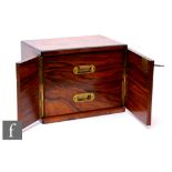 A small Victorian figured walnut table cabinet fitted with two drawers enclosed by a pair of