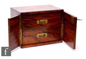 A small Victorian figured walnut table cabinet fitted with two drawers enclosed by a pair of