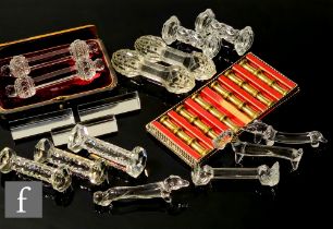 A large quantity of 19th and 20th Century assorted clear crystal knife rests, mostly pairs, of