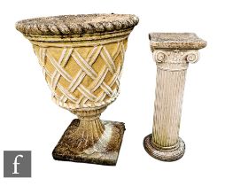 A reconstituted stone garden urn of pedestal form with trellis work sides, height 69cm, together