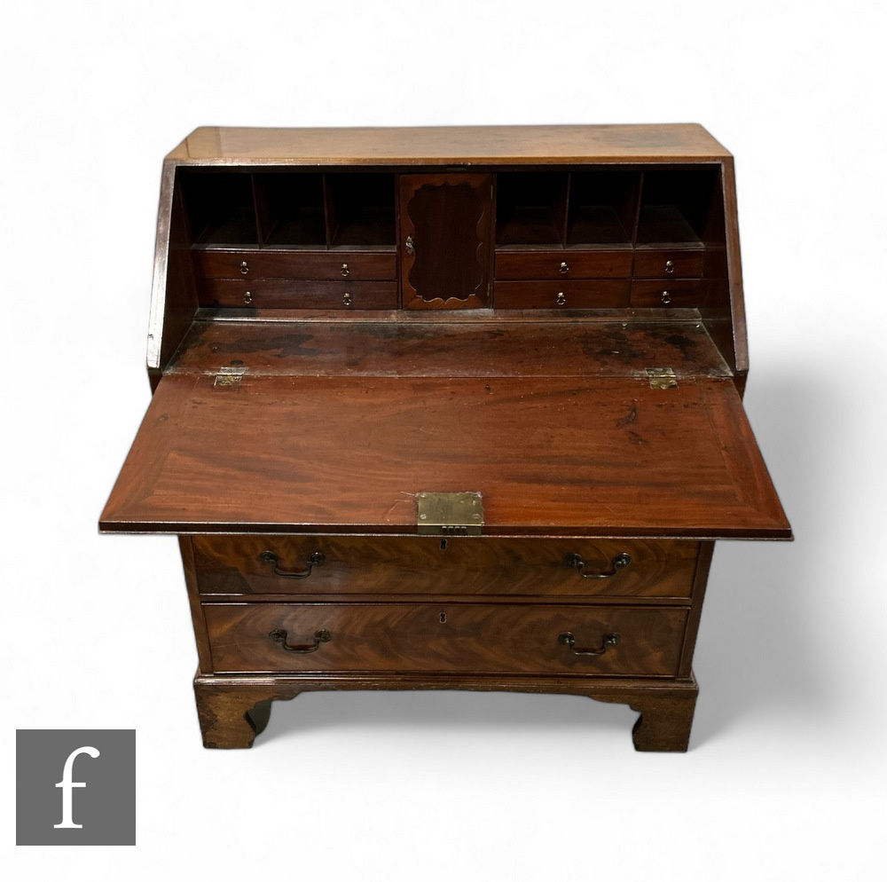 A 19th Century mahogany bureau, the fall front enclosing an arrangement of drawers, above four - Image 2 of 2