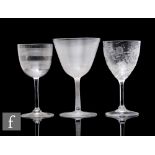 A late 19th Century clear crystal wine glass, the ovoid bowl with fine engraved lines, engraved