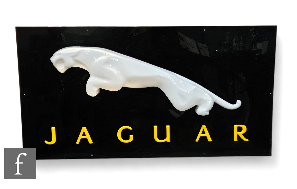 A post 1970s pictorial Jaguar Perspex display sign, raised white leaping Jaguar over gold