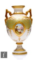 A Coalport porcelain pedestal vase, circa 1900, of rounded form rising from a spreading circular