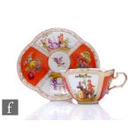 An early 20th Century Dresden lobed cup and saucer the segmented orange and figural ground picked
