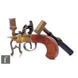 A 1970s flintlock pistol desk lighter with chamber stick attachment and a shot measure. (2)