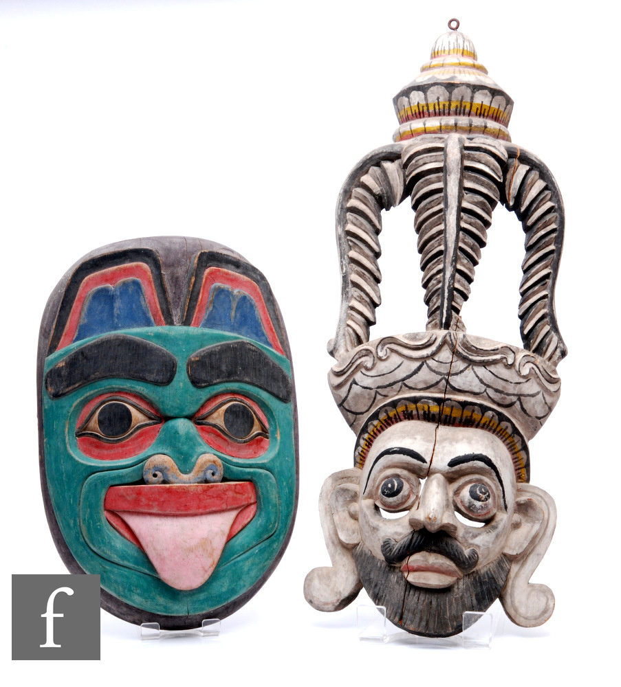 Two carved wooden masks, to include a Sri Lankan Raksha mask, length 60cm, and a Pacific North
