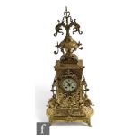 A large Victorian style brass mantle clock in the Renaissance style, Arabic dial with eight day